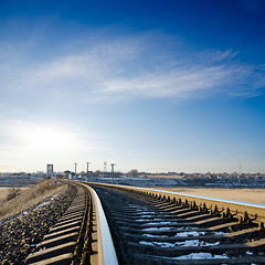 Image showing railroad to horizon under deep blue sky in sunset