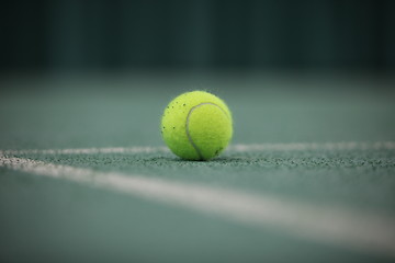 Image showing Close up of a tennis ball in the foreground