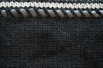 Image showing woollen knit sweater leather stitch closeup 