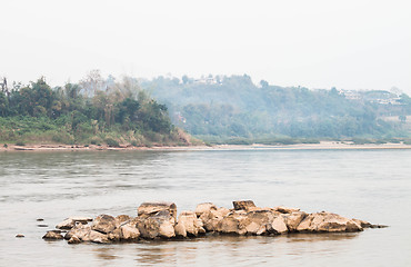 Image showing Peaceful scenic view of rocks middle the river