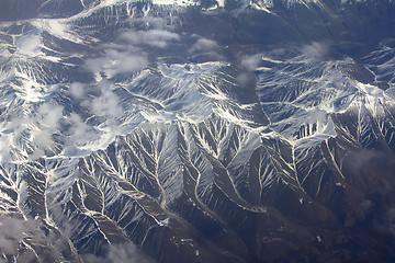 Image showing Pattern of snow, clouds and stones: view from height.