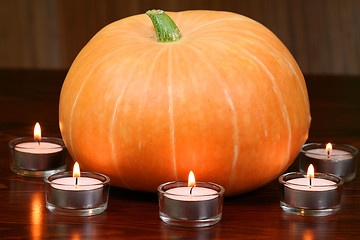 Image showing Pumpkin in light of candles