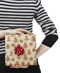 Image showing Young woman holding a present