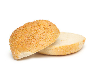 Image showing One whole bun with sesame seeds and half of the bun
