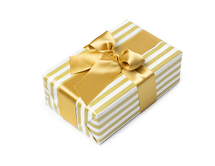 Image showing Gift box in gold duo tone with golden satin ribbon and bow isolated over white background.