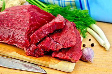 Image showing Meat beef on a wooden board with a knife