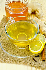 Image showing Tea ginger on a napkin of burlap with honey