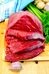 Image showing Meat beef on a wooden board with garlic