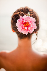 Image showing brunette woman with pinkroses in hair, vertical orientation