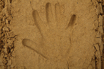 Image showing hand print in the sand 