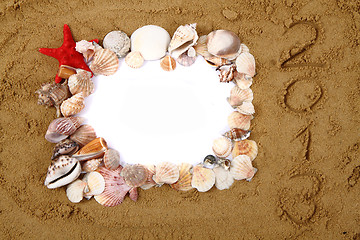 Image showing sea shells, paper and yellow sand