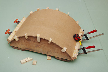 Image showing Gluing the arch of hardboard  on  rule