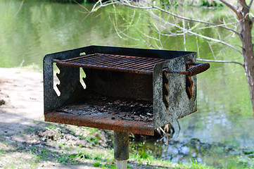 Image showing Rusted charcoal grill at a Park