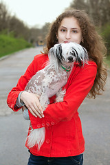 Image showing Girl holding little dog