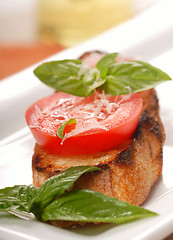 Image showing Bruschetta topped with fresh tomato and basil