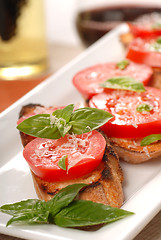 Image showing Bruschetta topped with fresh tomato and basil