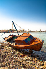 Image showing Red rowboat lying at shore