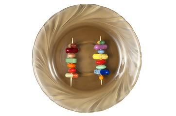 Image showing Toothpicks with Pills on a Plate