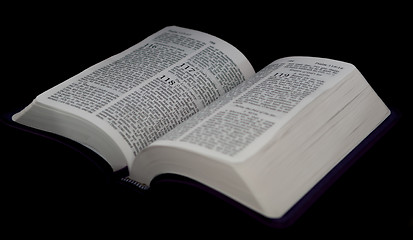Image showing open Bible to psalm 118 isolated on a black background.