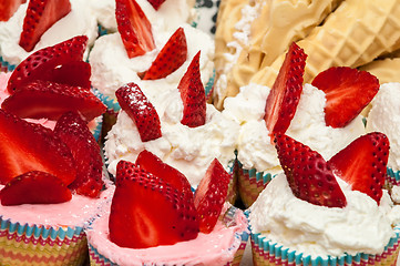Image showing Delicious vanilla cupcake with strawberry frosting and fresh str