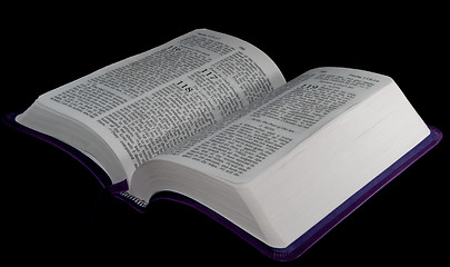 Image showing open Bible to psalm 118 isolated on a black background.