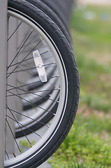 Image showing tires with reflector of parked bikes in a city