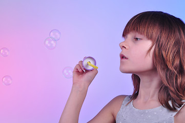 Image showing girl blowing soap bubbles