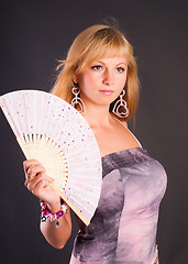 Image showing Beautiful young woman with fan