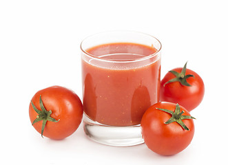 Image showing Glass of tomato juice and tomatoes