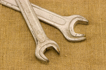 Image showing pair screw spanners wrench tools crossed on linen 