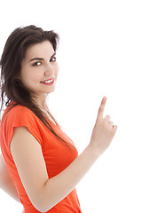 Image showing Brunette young woman pointing up