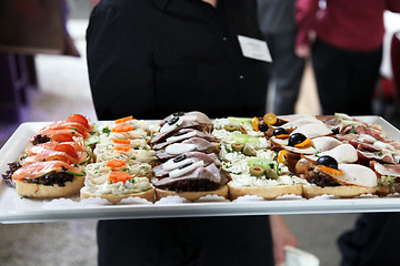 Image showing Waiter offering a tray of appetizers