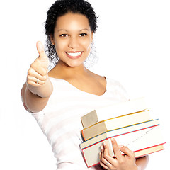 Image showing Woman carrying textbooks giving a thumbs up