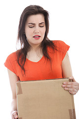 Image showing Young brunette woman carrying a cardboard box