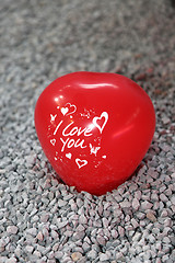 Image showing Red shaped heart with writing sitting on pebbles