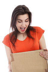 Image showing Surprised young woman holding a cardboard box