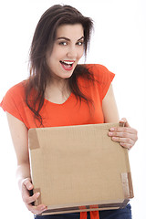 Image showing Happy young woman holding a cardboard box