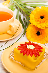 Image showing tea with cake and gerberas flowers