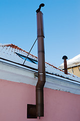 Image showing Metal chimney at a wall of a building