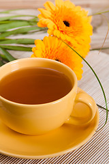 Image showing tea with cake and gerberas flowers