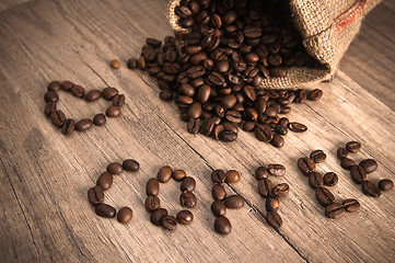 Image showing Grains of coffee on a wooden surface