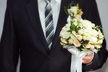 Image showing Groom with a bouquet