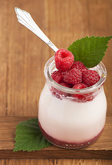 Image showing White yogurt in a glass jar with raspberry