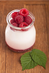 Image showing White yogurt in a glass jar with raspberry