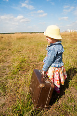 Image showing lonely girl with suitcase. Back view