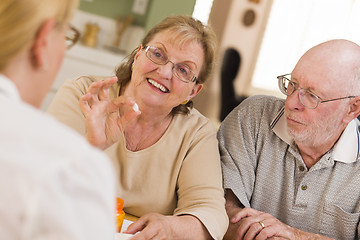 Image showing Doctor or Nurse Explaining Prescription Medicine to Senior Coupl