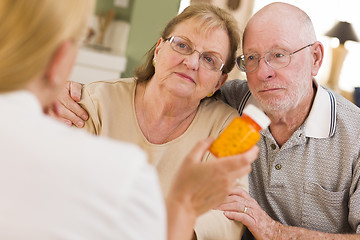 Image showing Doctor or Nurse Explaining Prescription Medicine to Senior Coupl