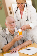 Image showing Doctor or Nurse Explaining Prescription Medicine to Senior Man