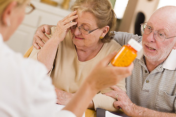 Image showing Doctor or Nurse Explaining Prescription Medicine to Senior Coupl