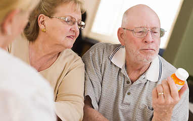 Image showing Doctor or Nurse Explaining Prescription Medicine to Senior Coupl